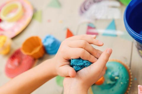 Close up of kids hands shaping play-doh