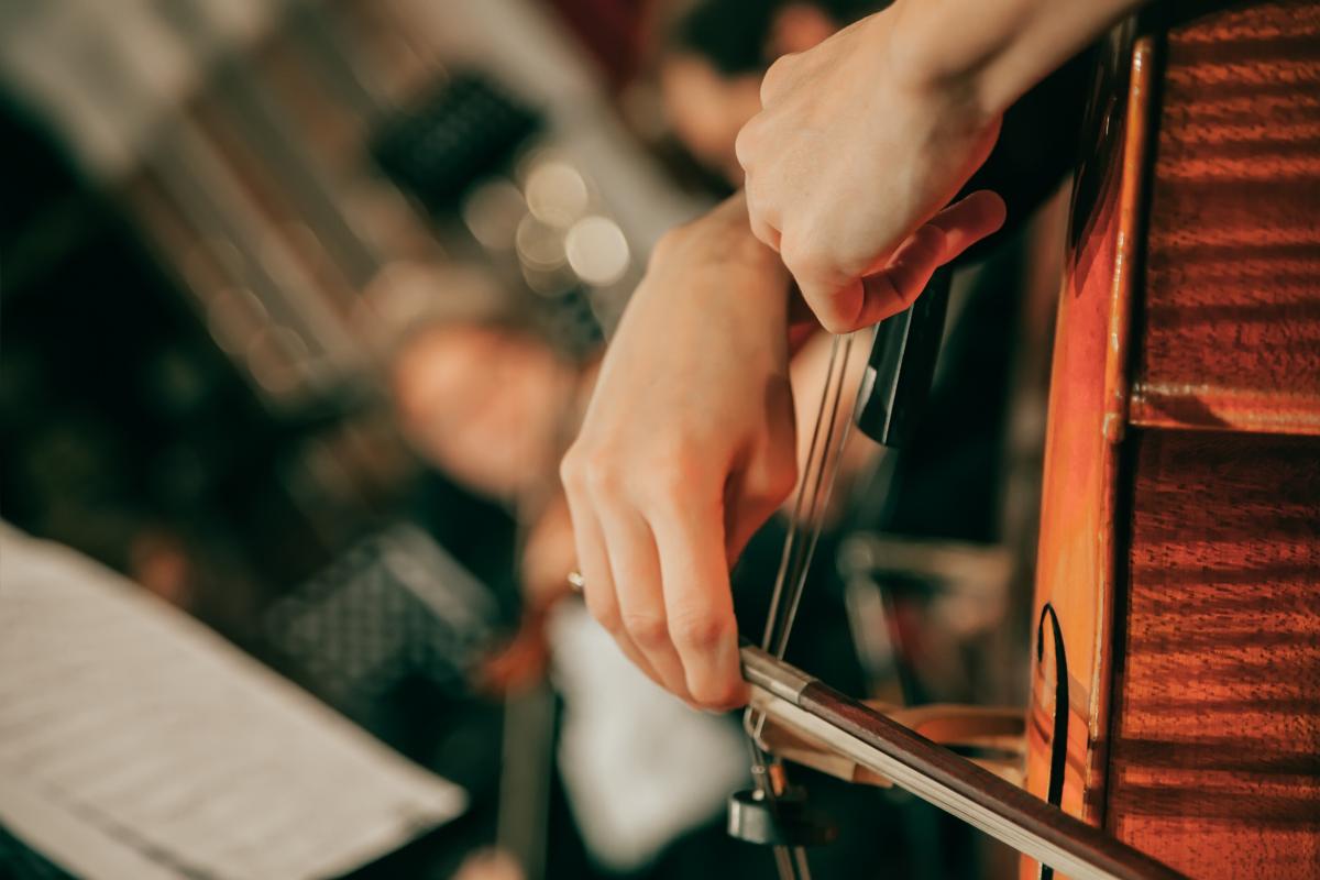 Person Holding Bow Playing Cello