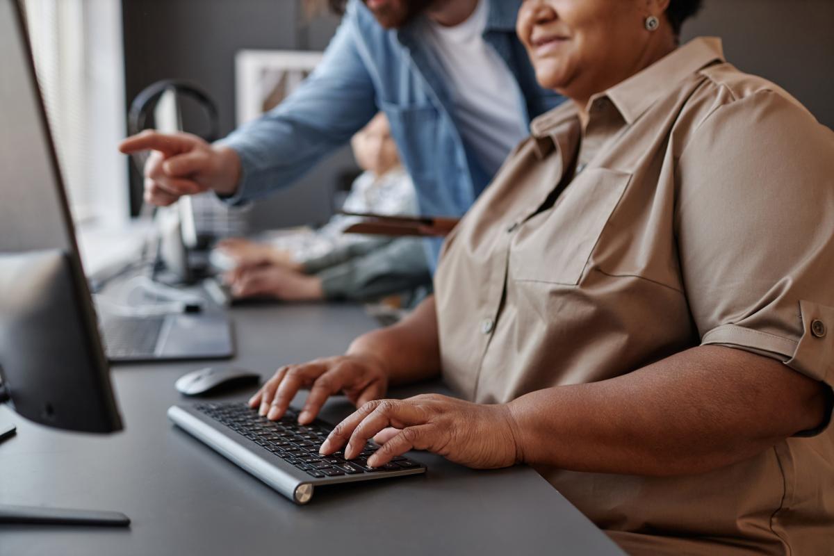 Close up view of adult receiving computer instruction